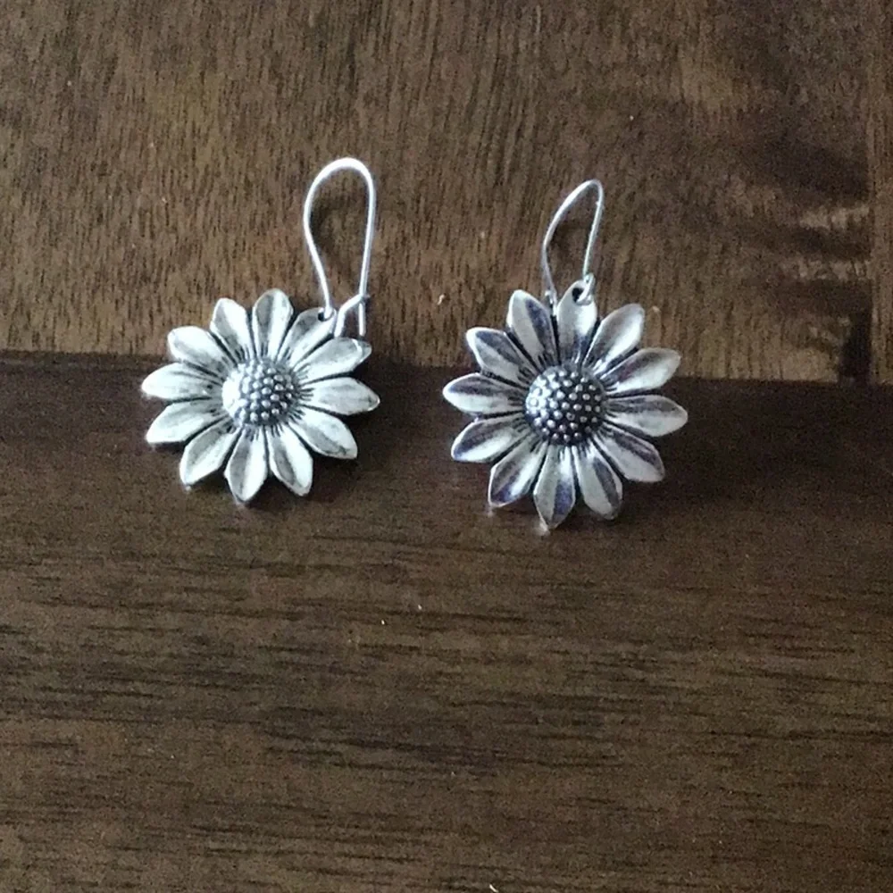 Flower dangle earrings silver in color